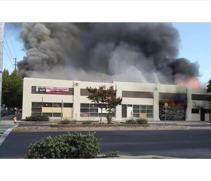 A fire burns through roof of commercial building 