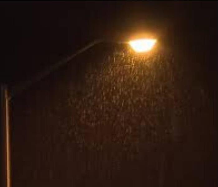 rainfall on an evening sky background with a streetlight