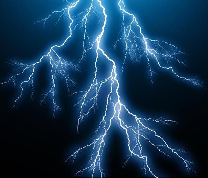 blue lightning strikes against the black night sky.